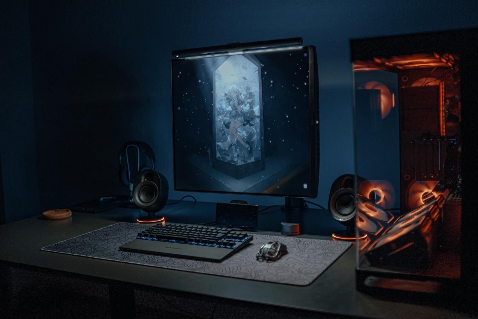 A stylish gaming setup featuring a screen, keyboard, and PC with ambient lighting for gamers shopping at an online game store.