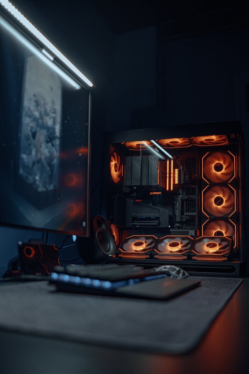 A sleek gaming PC setup with RGB lighting and a high-resolution monitor showcasing gaming products available through an online game store.