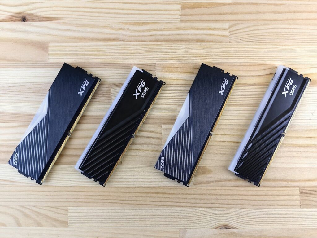 Four computer ram sticks on a wooden surface